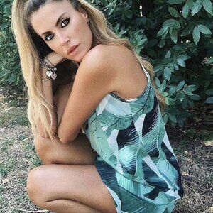 new Spring Forward In this leaf print sleeveless mini dress. Soft chiffon fabric